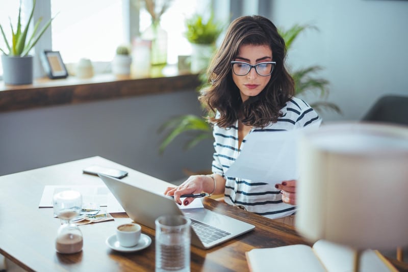 Femme qui prépare des bulletins de paie sur son ordinateur