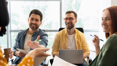 Des collaborateurs échangent en souriant