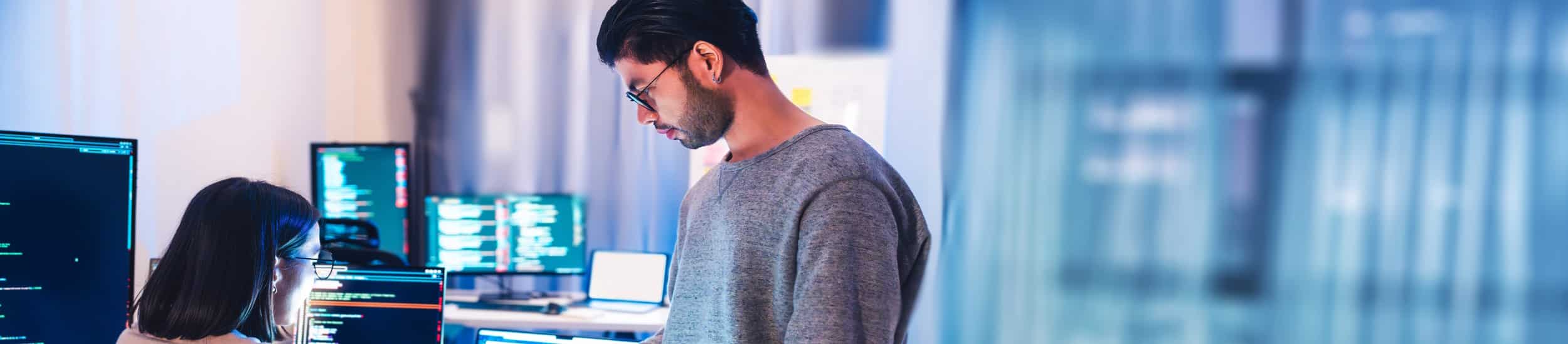 Un homme travail sur un ordinateur en tant qu'éditeur de logiciels métier